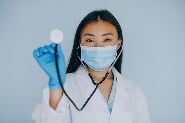 Молодая женщина-хирург на синем фоне со стетоскопом