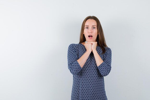 Young woman surprising on white background