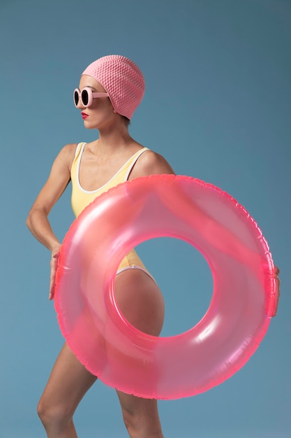 Young woman in swimsuit with a swimming ring