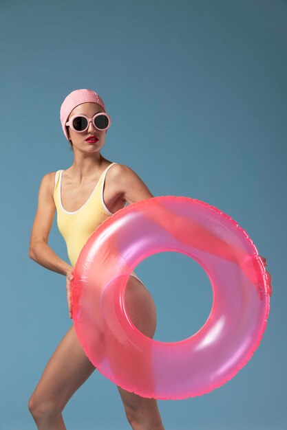 Young woman in swimsuit with a swimming ring