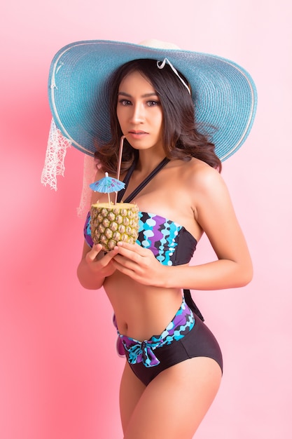 young woman in swimwear isolated over pink