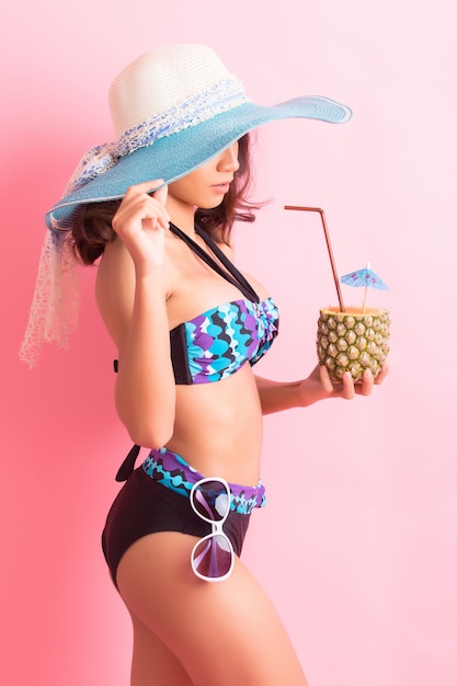 young woman in swimwear isolated over pink