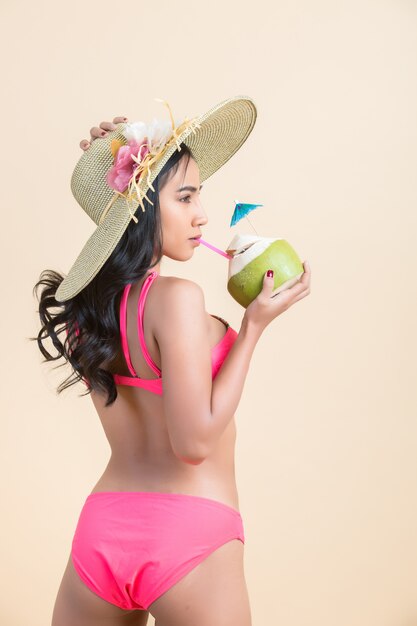 young woman in swimwear with coconut