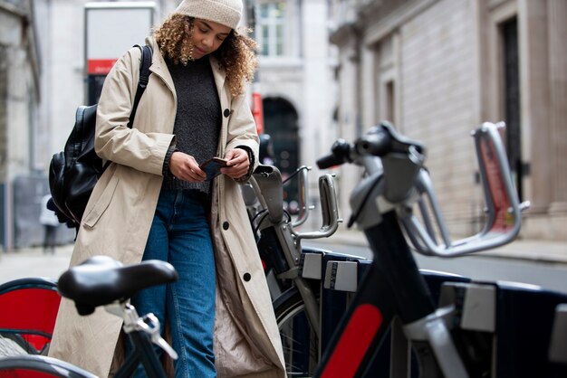 Young woman taking a bike to ride it in the city