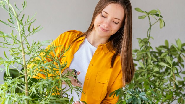 Young woman taking care of green plants