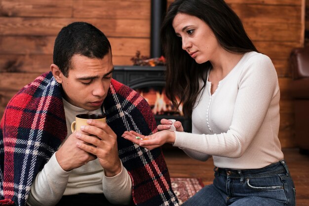 Young woman taking care of man