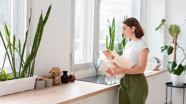 Young woman taking groceries out of bag