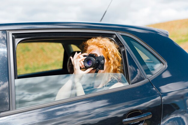 Young woman taking pictures on chamber