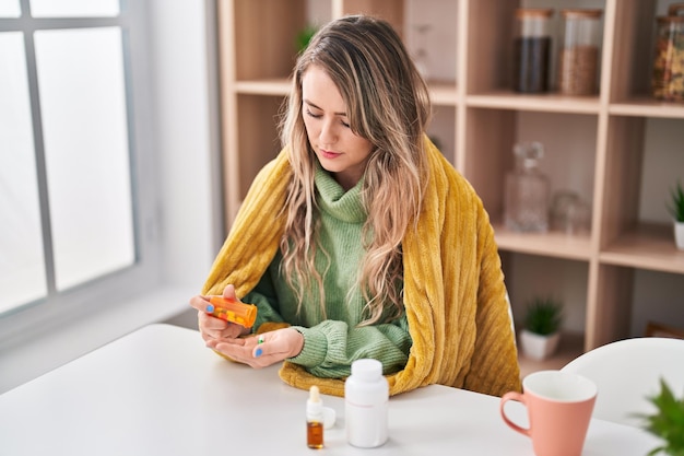 Free photo young woman taking pills at home