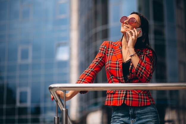 Young woman talking on the phone by the office center