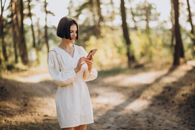 Young woman talking on the phone in park