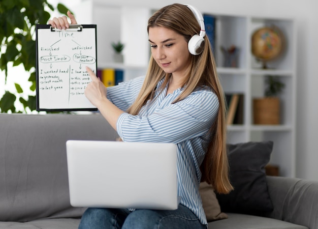 Young woman teaching kids in english class online