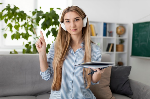 Young woman teaching kids in english class online