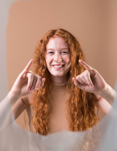 Young woman teaching sign language