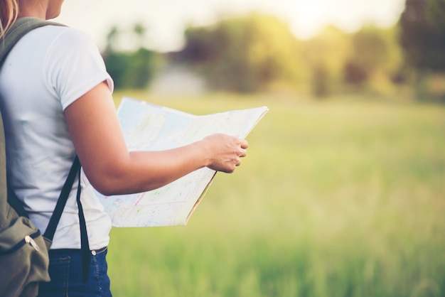 Young woman tourist holding map on trip