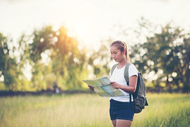 Young woman tourist holding map on trip