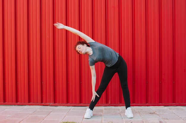 Young woman training body outside