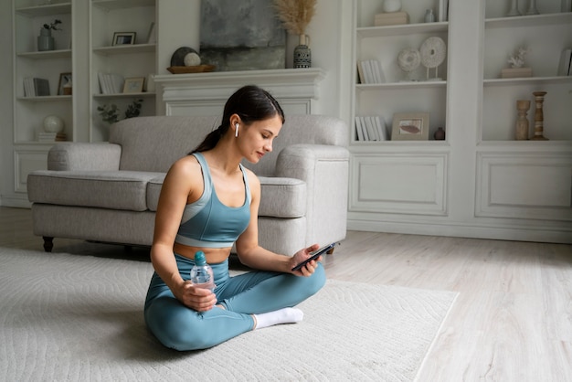 Young woman training at home alone