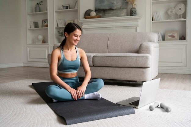 Young woman training at home alone