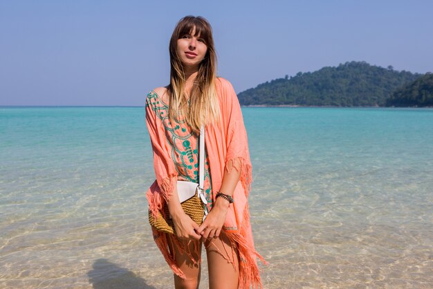 Young woman in trendy boho beach dress