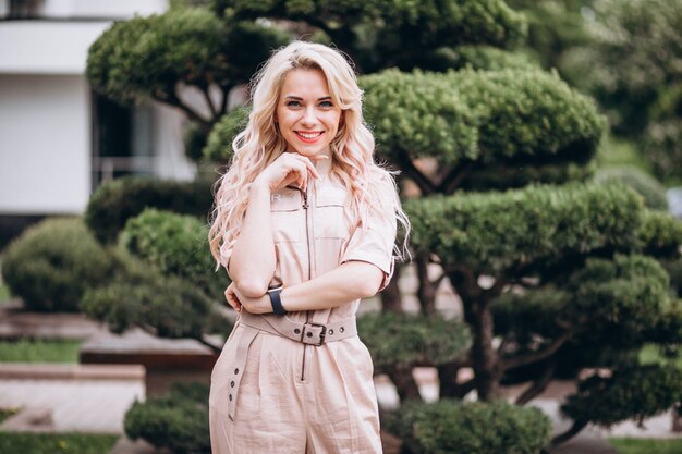 Young woman in trendy pink overall