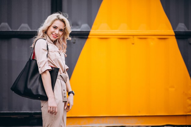 Young woman in trendy pink overall