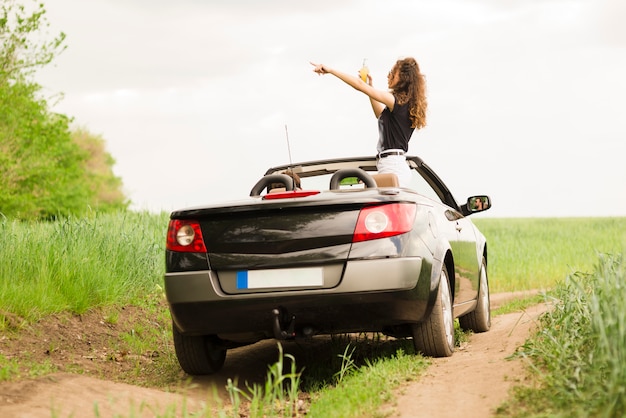 Free photo young woman on a trip in a car