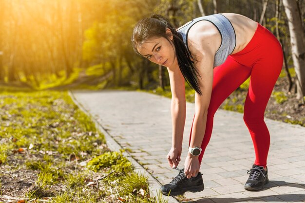 Young woman tying her sneaker