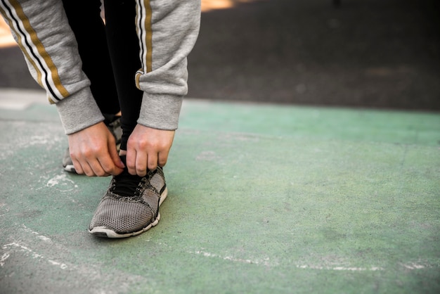 Young woman tying her sneakers