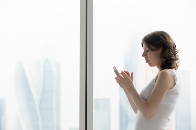 Young woman typing smartphone message