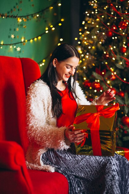 Young woman unpacking christmas gift