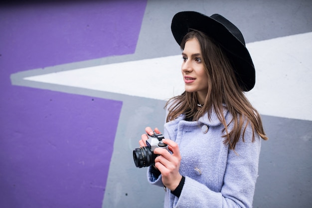 Young woman using beach camera