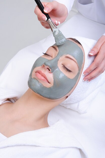 Young woman using cosmetic procedure in the beauty salon