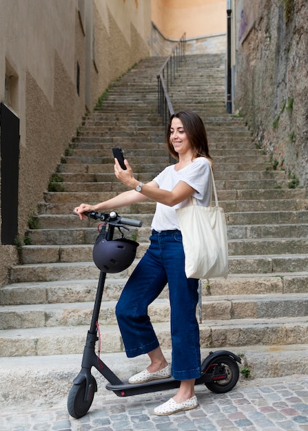 Young woman using an eco scooter