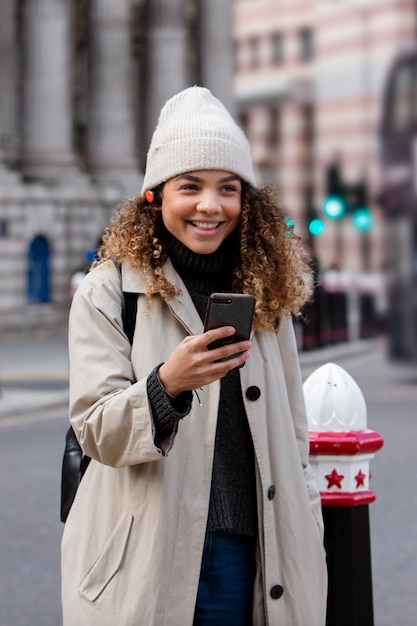 Young woman using her smartphone in the city