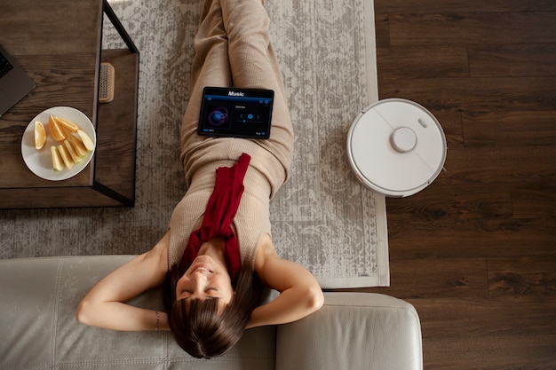 Free photo young woman using home technology