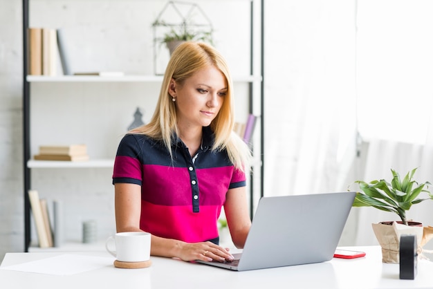 Young woman using laptop over desk