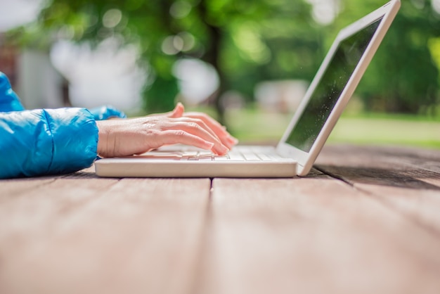 Free photo young woman using laptop outside room,happy moment on holiday, l