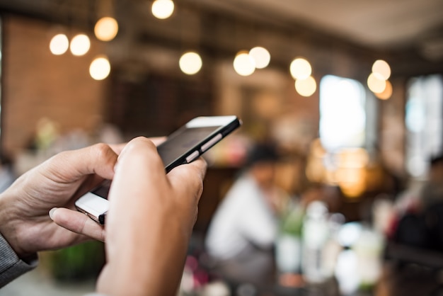 Young woman using and looking at smartphone with feeling happy