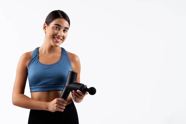 Young woman using message gun