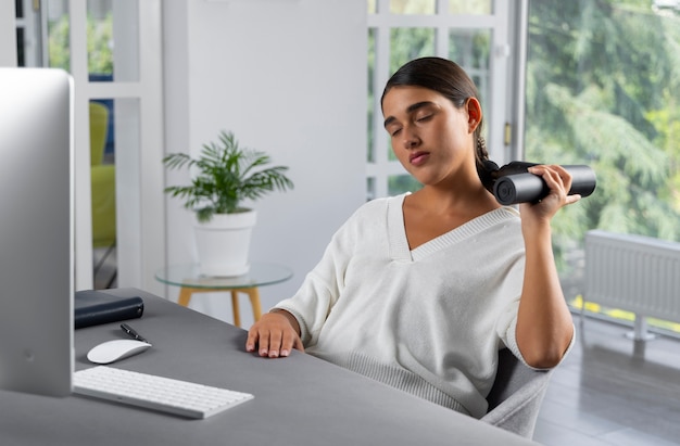 Young woman using message gun