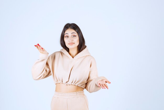 Young woman using open hands to present and talk about something