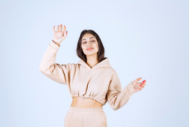 Young woman using open hands to present and talk about something