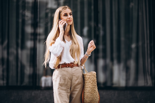 Young woman using phone out in the city