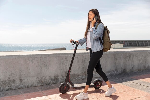 Young woman using a scooter outdoors