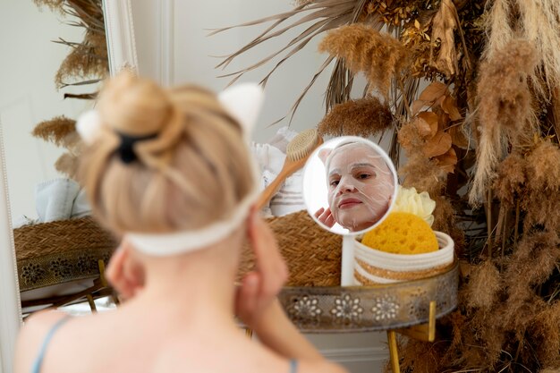 Young woman using a selfcare face mask