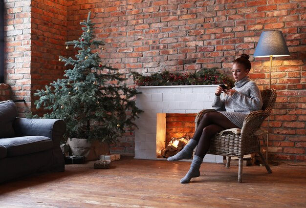 Young woman using smartphone at home