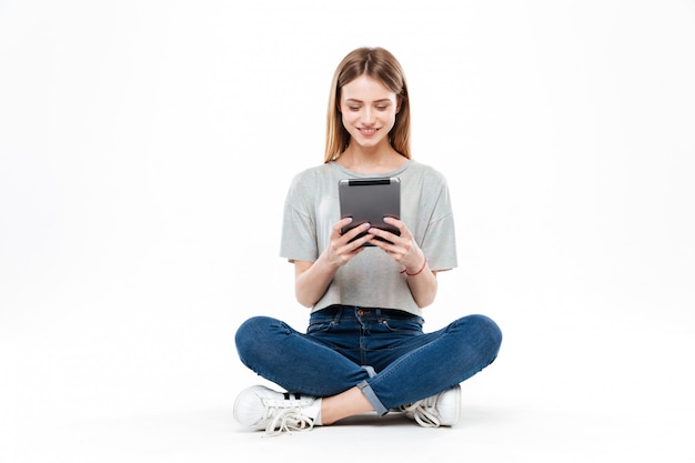 Young woman using tablet isolated
