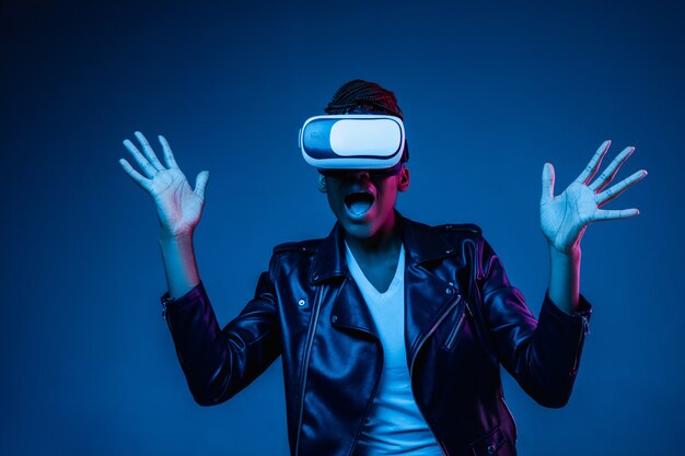 Young woman using VR-glasses with neon lights