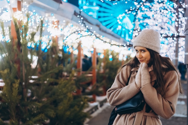 Free photo young woman walking on market with trees